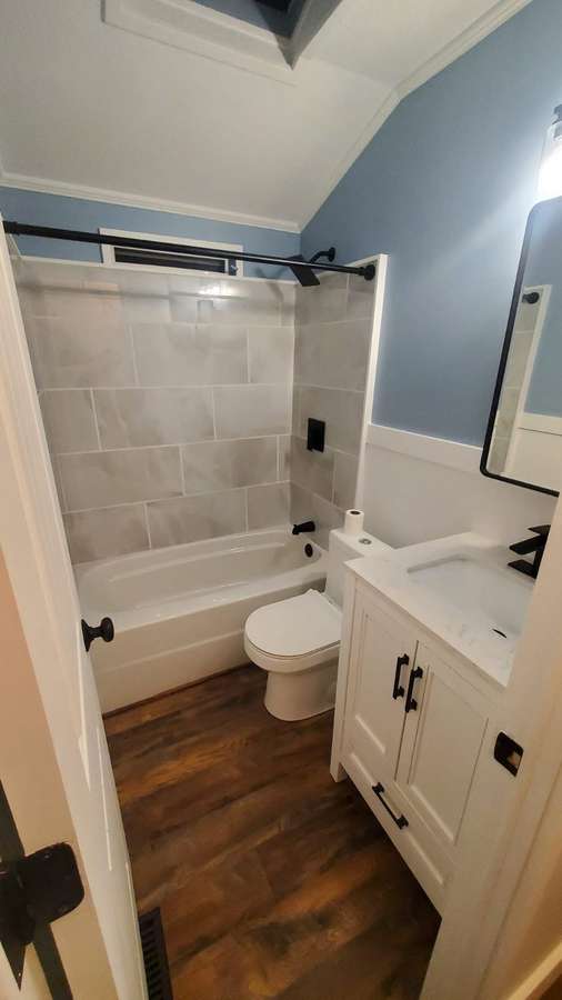 Remodeled bathroom with a tiled tub surround