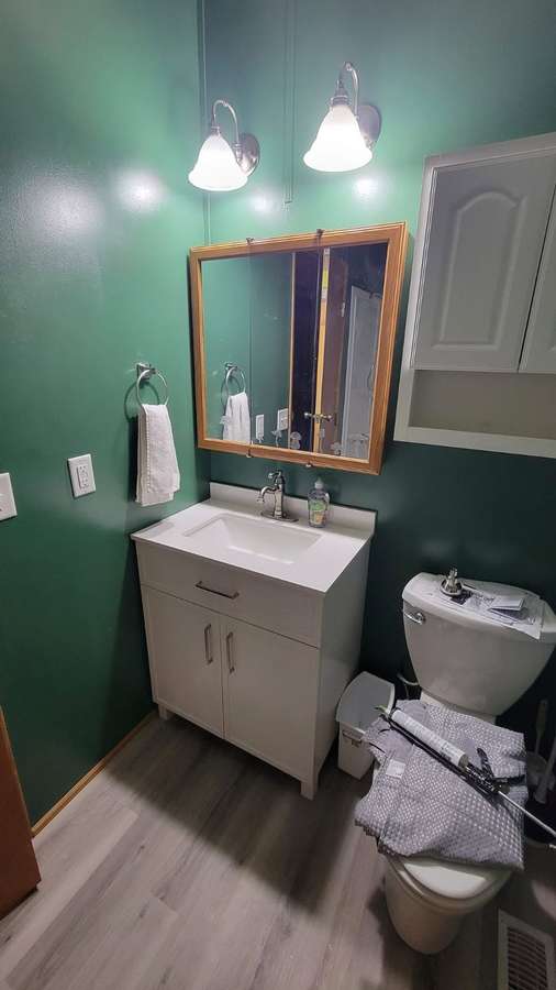 Bathroom with a new vanity and mirror
