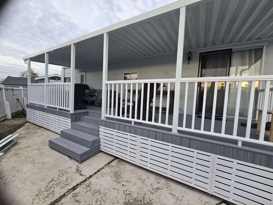 Covered 8 by 30 composite deck with white railings