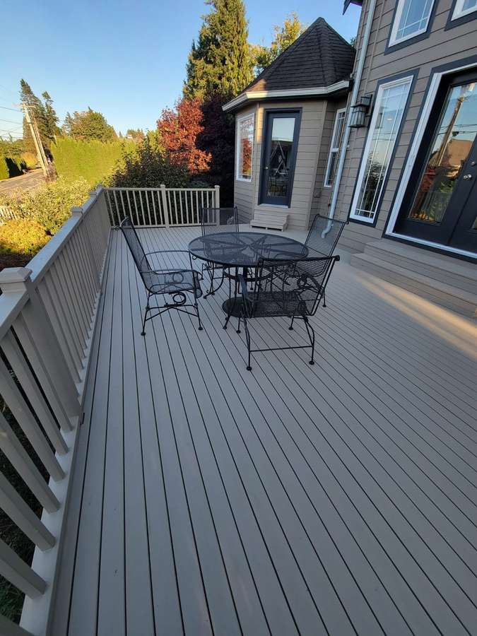Deck corner with railings and trees beyond