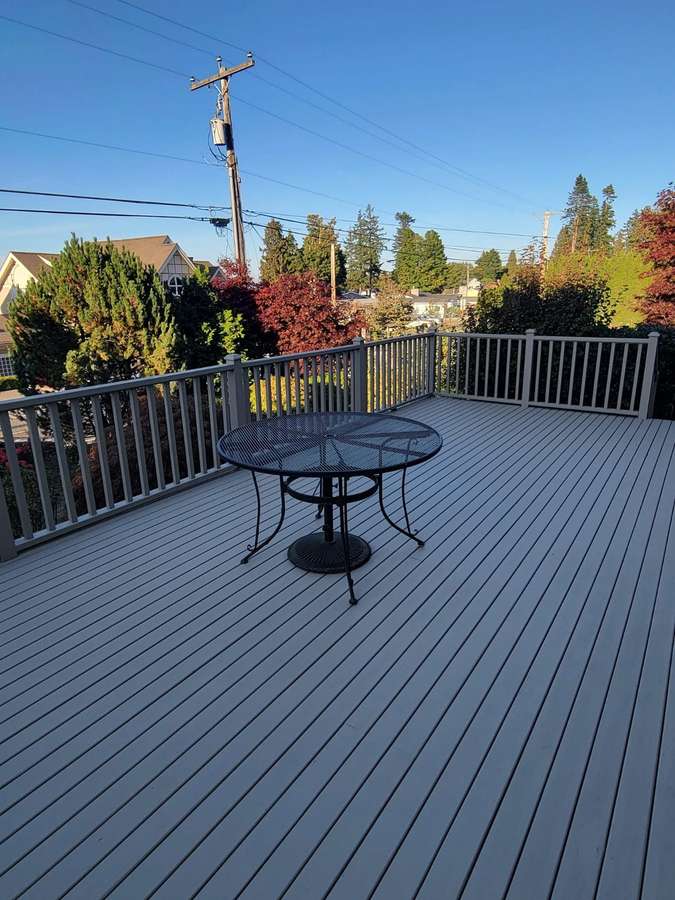 Rebuilt deck with patio table overlooking trees