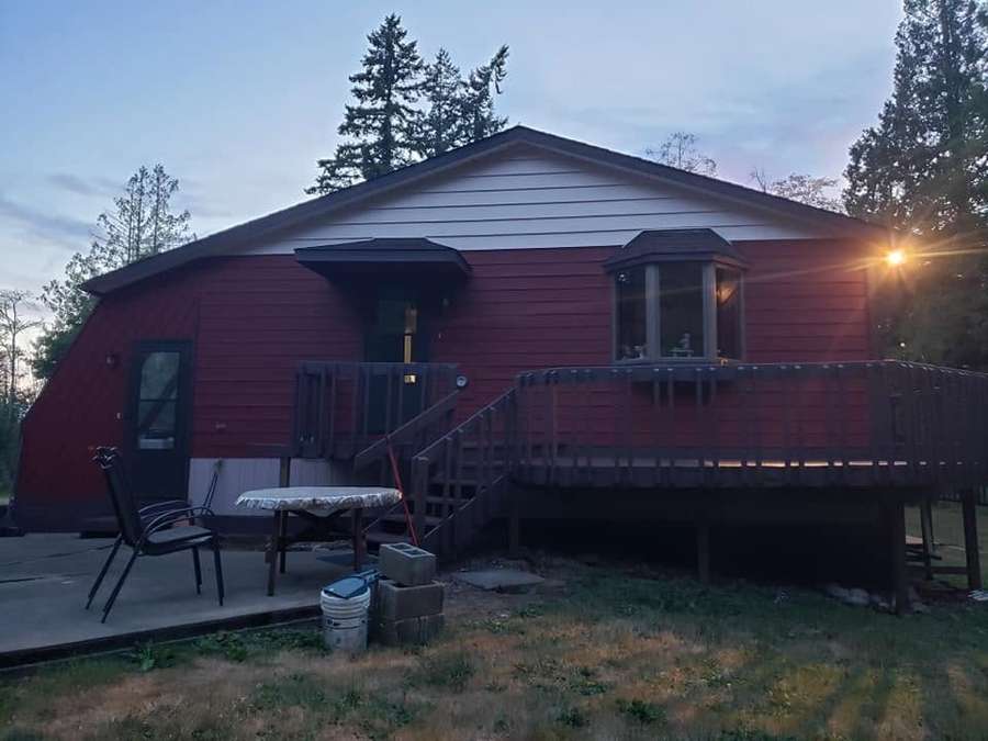 Home with fresh red siding and a back deck