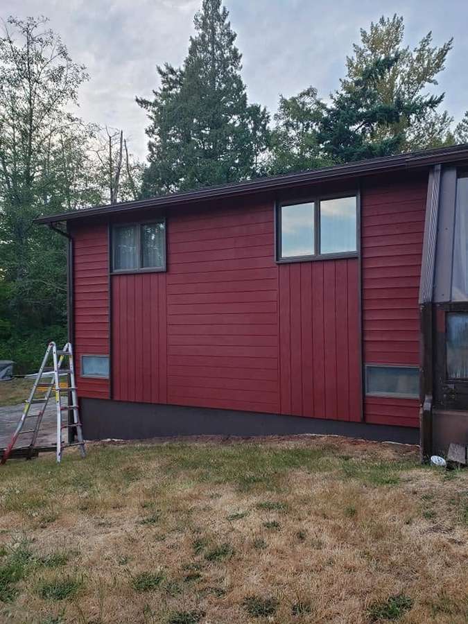 Two-story wall with new red siding