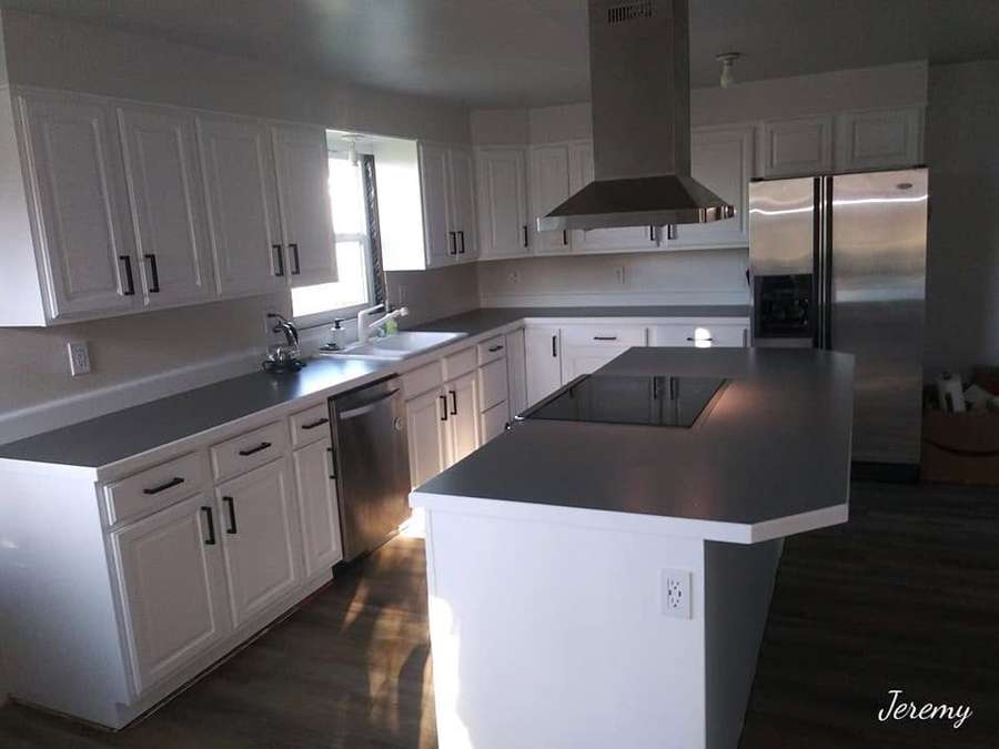 Kitchen with a range hood and white cabinets